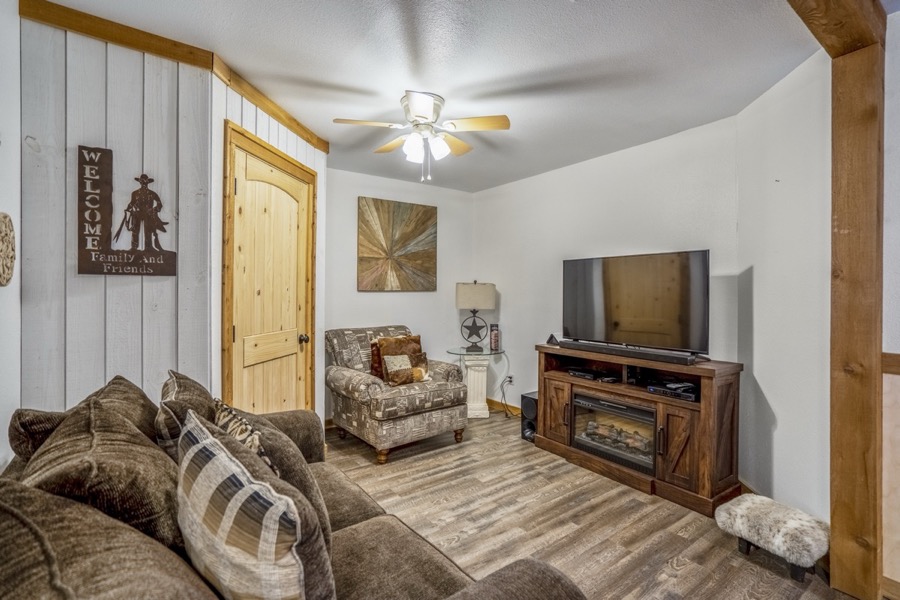 Inspira Ranch apartment living room with sectional sofa, large TV, and western ranch decor