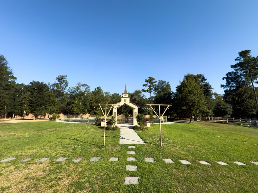 Inspira Ranch chapel and ceremony lawn framed by East Texas pine and oak forest