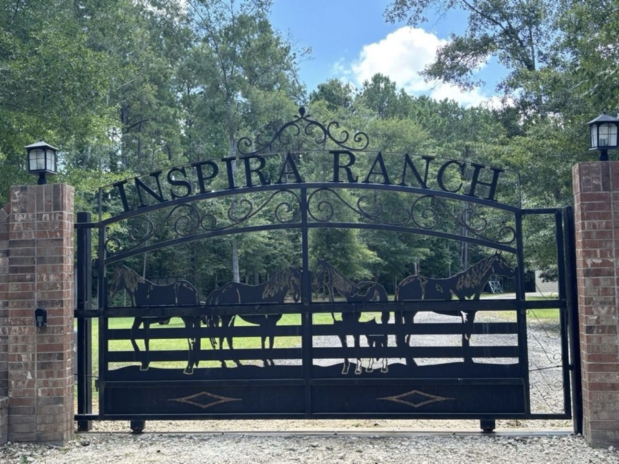 Inspira Ranch wrought-iron entrance gate at 638 Mill Gate Rd, Livingston TX — 14-acre private event venue