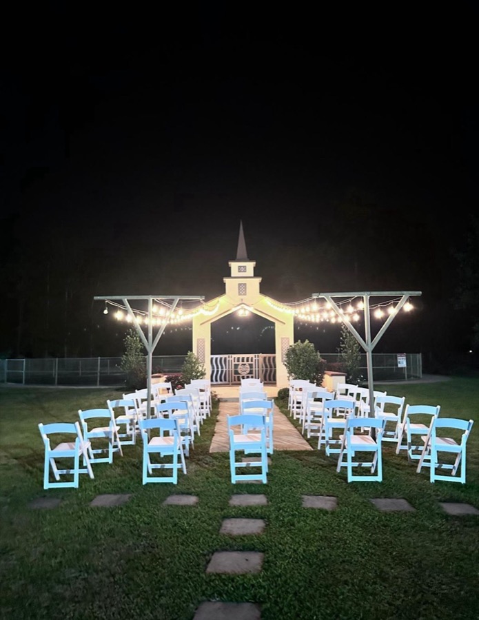 Inspira Ranch outdoor chapel at night with ceremony chairs and string lights — wedding venue near Houston TX
